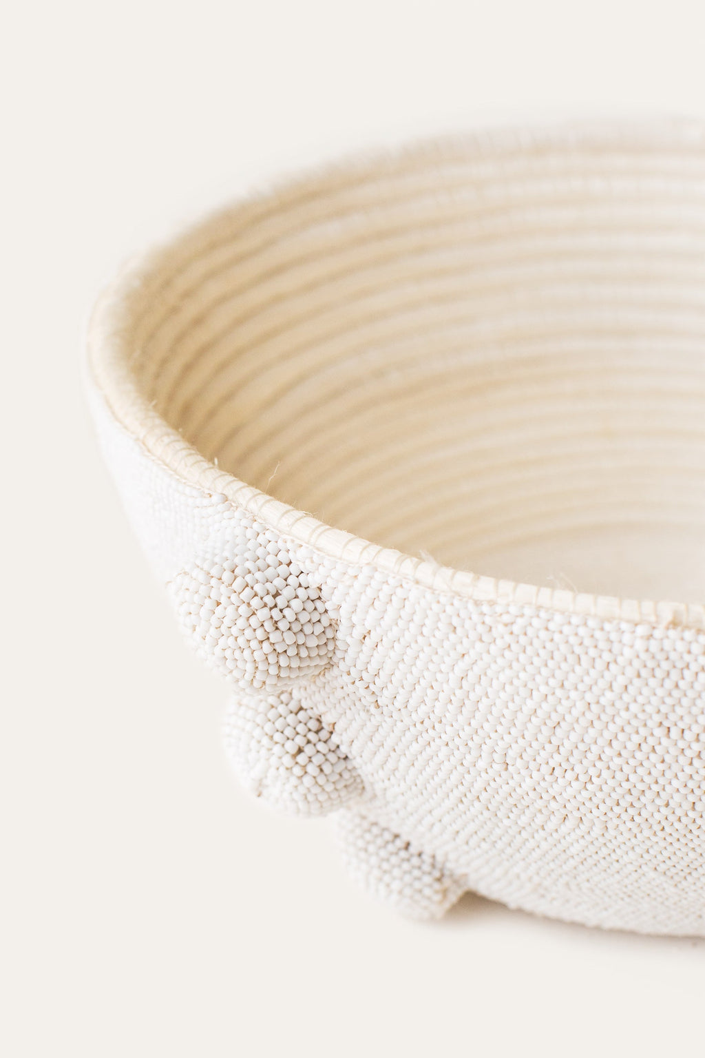 Close-up of a textured white ceramic bowl on a light background