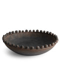Decorative black bowl with bead-like embellishments on a white background