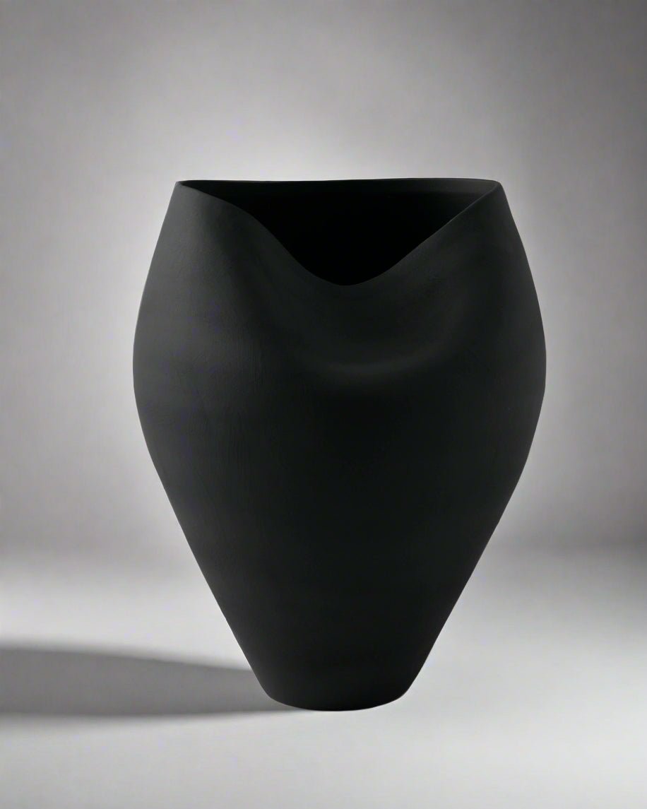 Black vase on a gray background