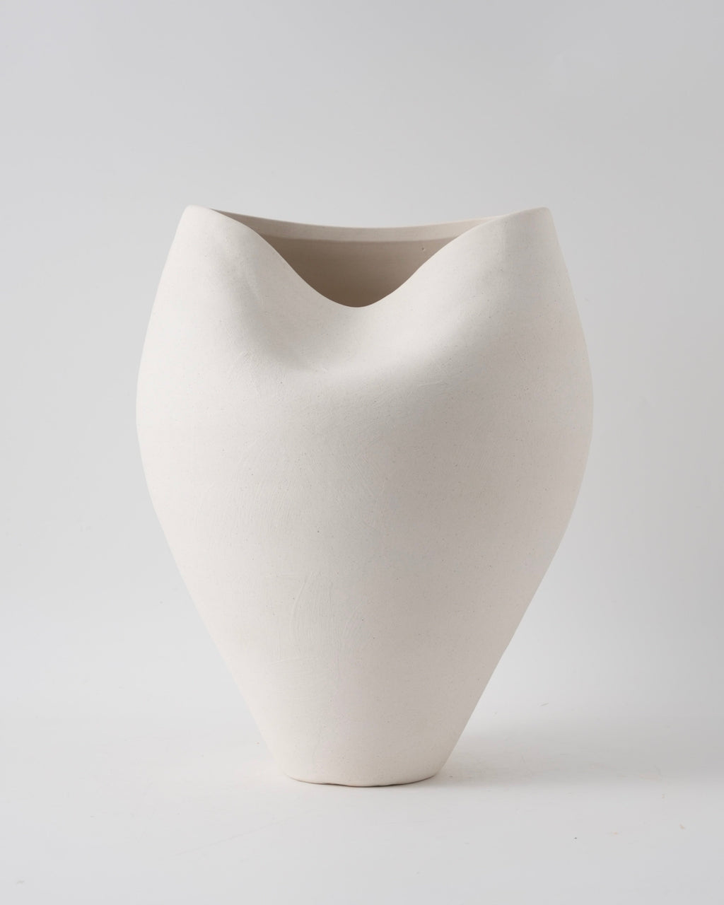 White ceramic vase on a light gray background