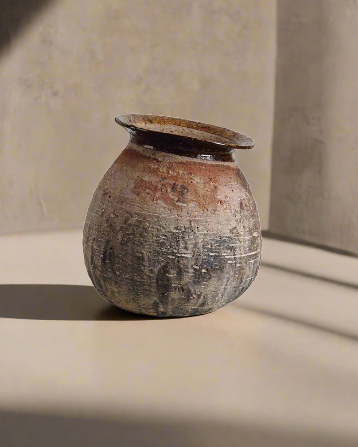 Vintage ceramic pot on a neutral background