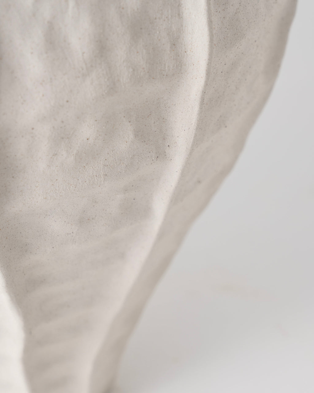 Close-up of beige fabric texture on a light gray background