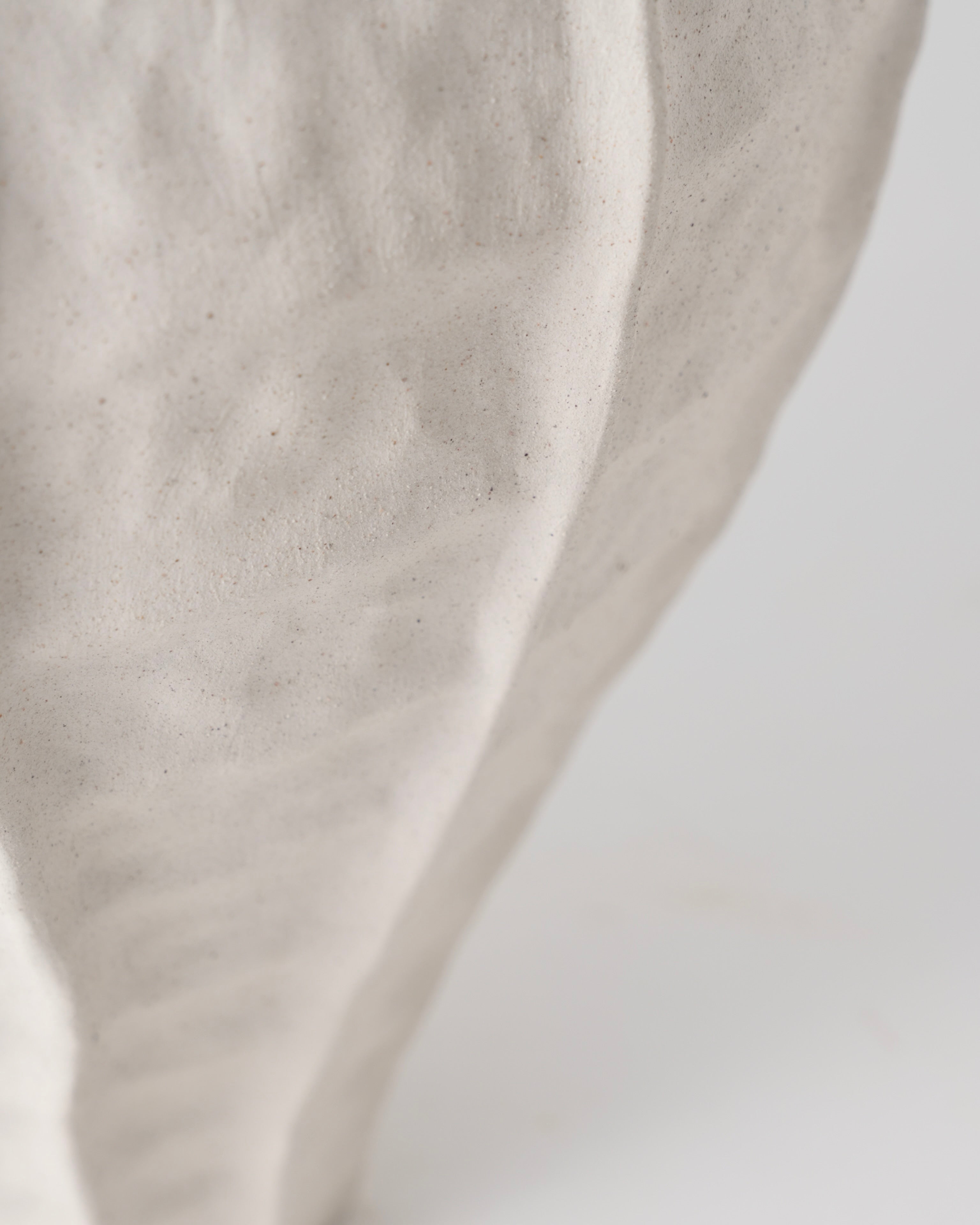 Close-up of beige fabric texture on a light gray background
