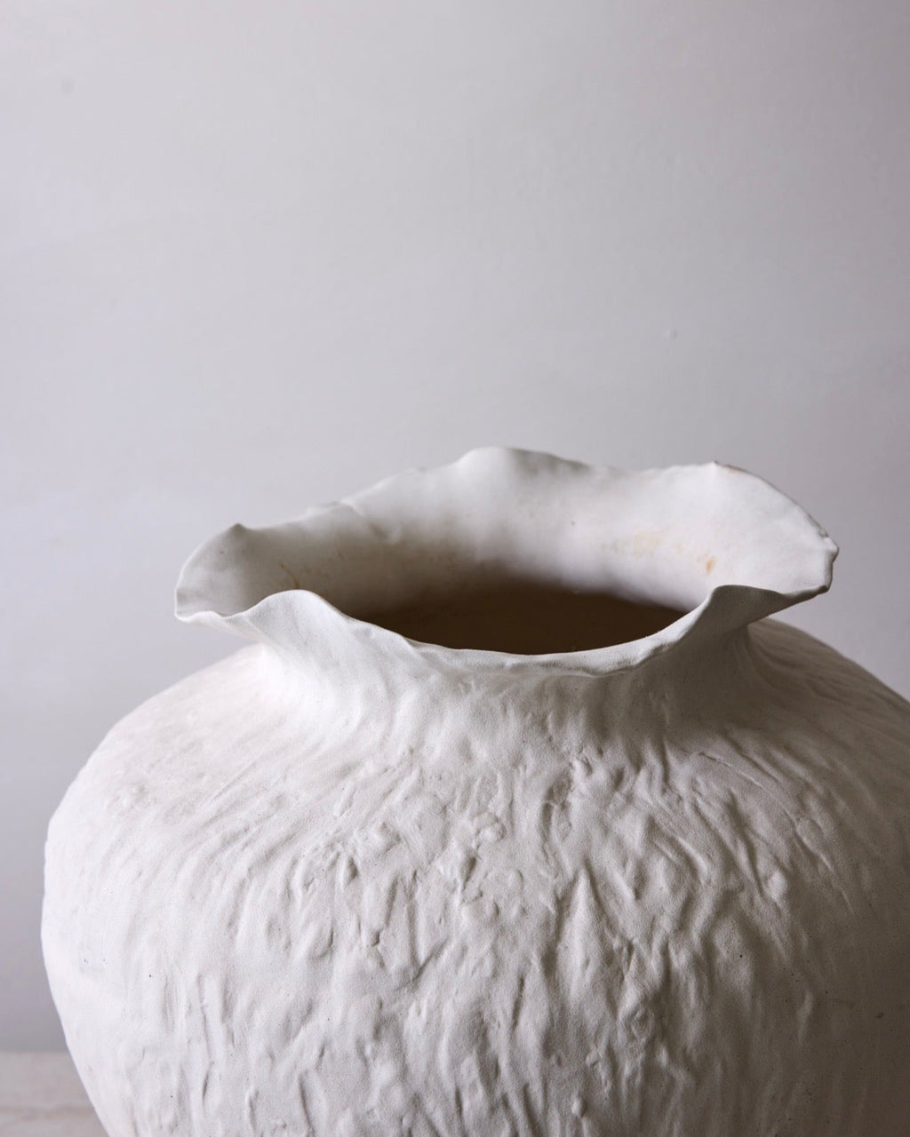 White textured vase on a light gray background