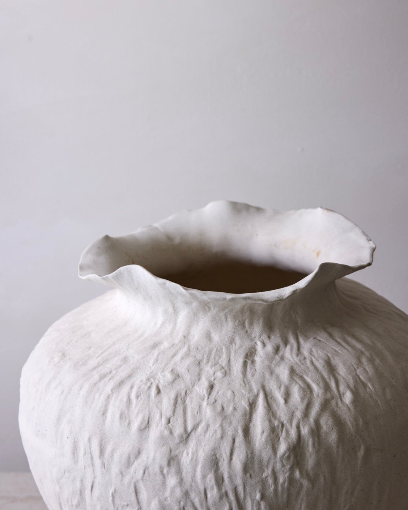 White textured vase on a light gray background