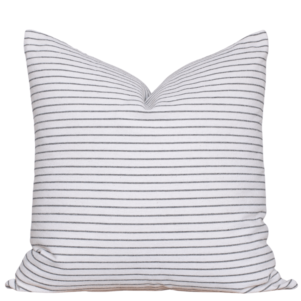 Striped pillow with blue and white stripes on a white background