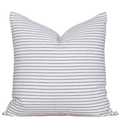 Striped pillow with blue and white stripes on a white background