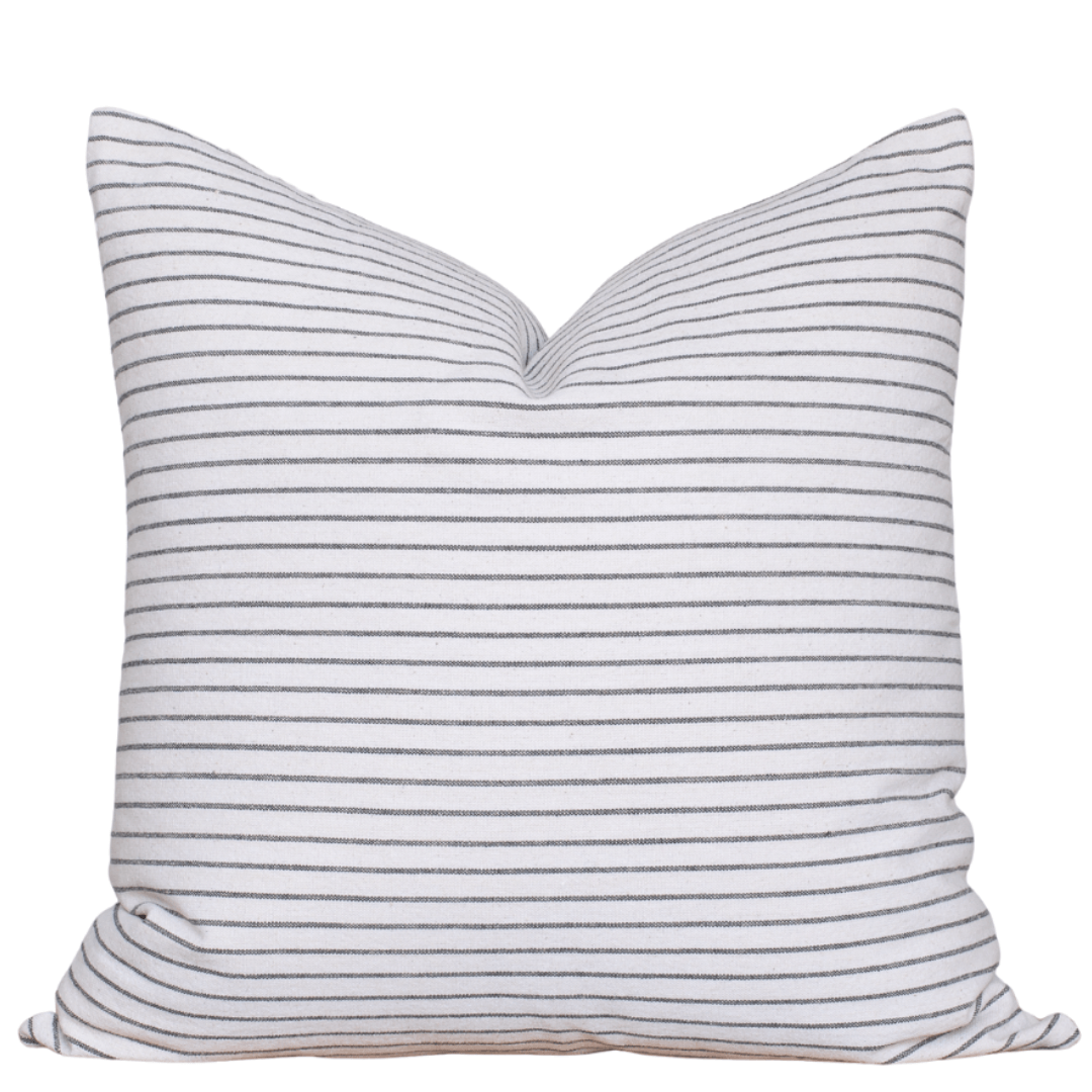 Striped pillow with blue and white stripes on a white background