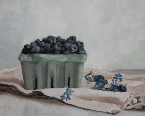 Blueberries in a crate fine art print featuring ripe blueberries gathered in a rustic berry basket on a draped cloth. Soft blue-gray tones, painterly brushstrokes, and neutral colors create timeless still life wall art for kitchens, dining rooms, and European-inspired interiors.