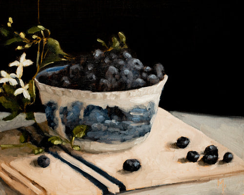 Blueberries in transferware bowl fine art print featuring ripe blueberries overflowing from a blue and white patterned bowl with delicate blossoms against a dark background. Rich painterly textures and dramatic lighting create timeless still life wall art for kitchens, dining rooms, and European-inspired interiors.