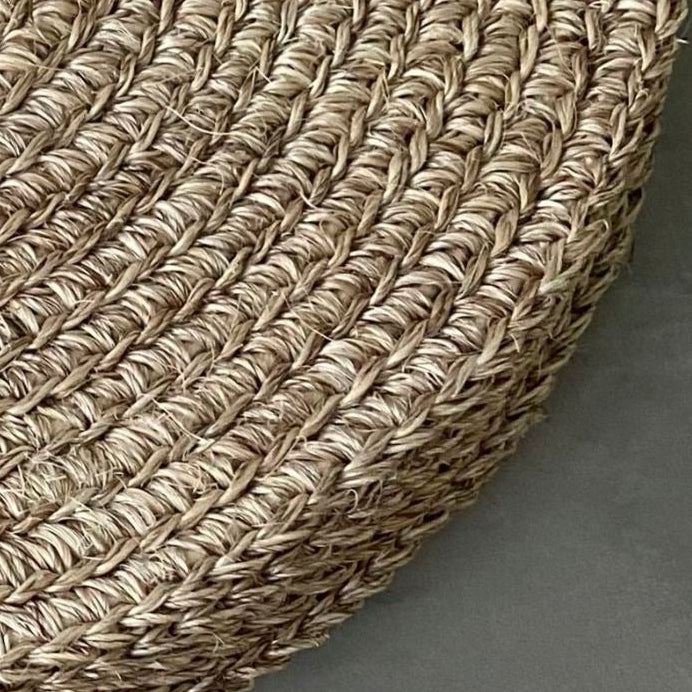 Handwoven round placemats in a soft natural beige tone featuring tightly braided woven texture and an organic neutral finish. Artisan-inspired woven table placemats styled with twine wrapping, perfect for European-inspired dining tables, layered tabletop decor, and timeless everyday entertaining-sorelle rossi shoppe