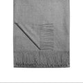 Gray blanket with fringes on a white background