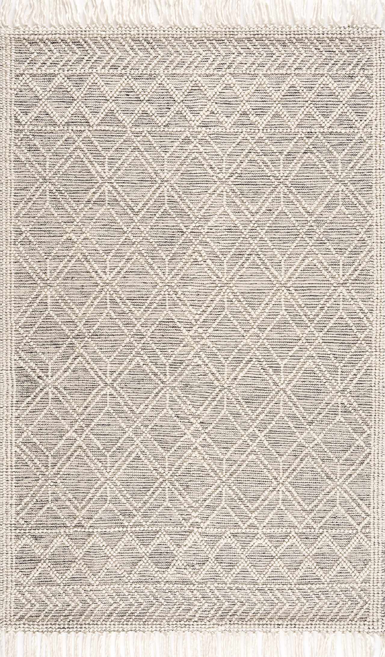 Gray and white geometric patterned rug with fringe on a white background