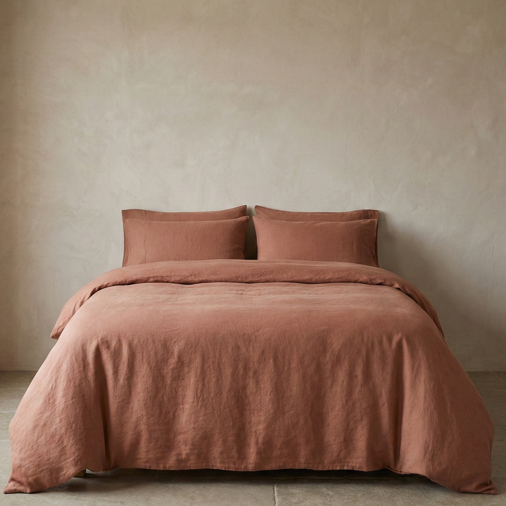 Brown bedding set on a bed against a beige wall