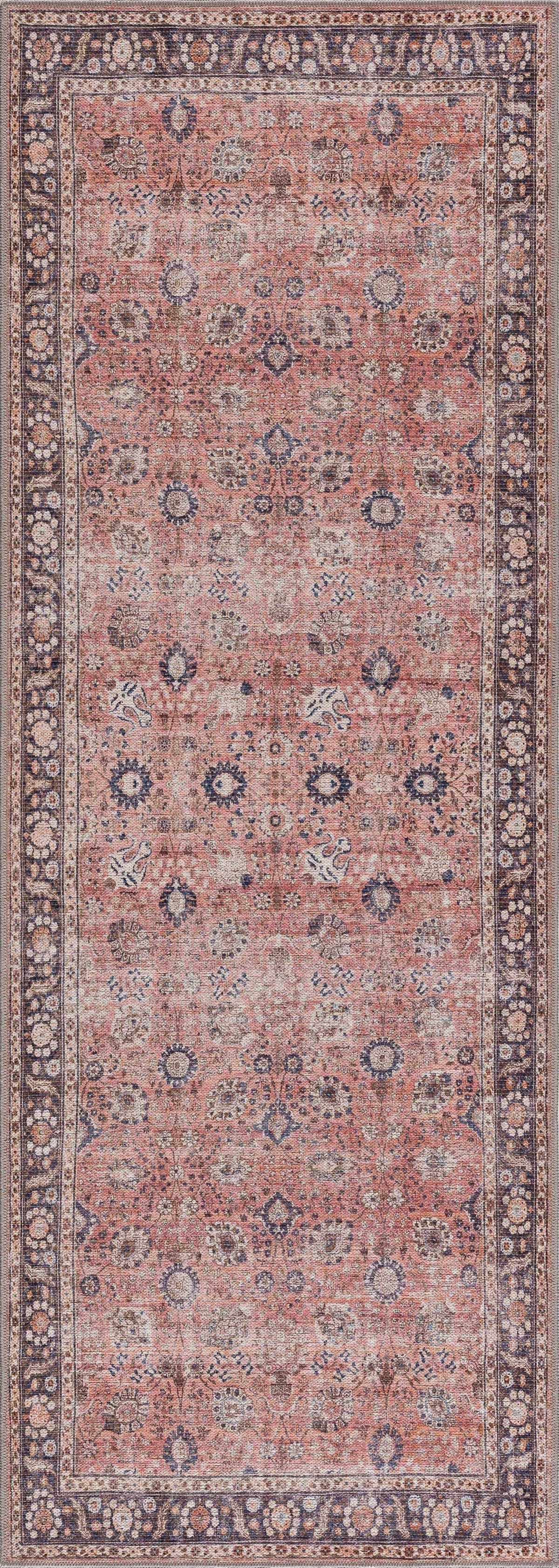 Patterned rug with a blend of red, brown, and beige colors on a plain background