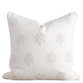 White decorative pillow with embroidered patterns on a white background