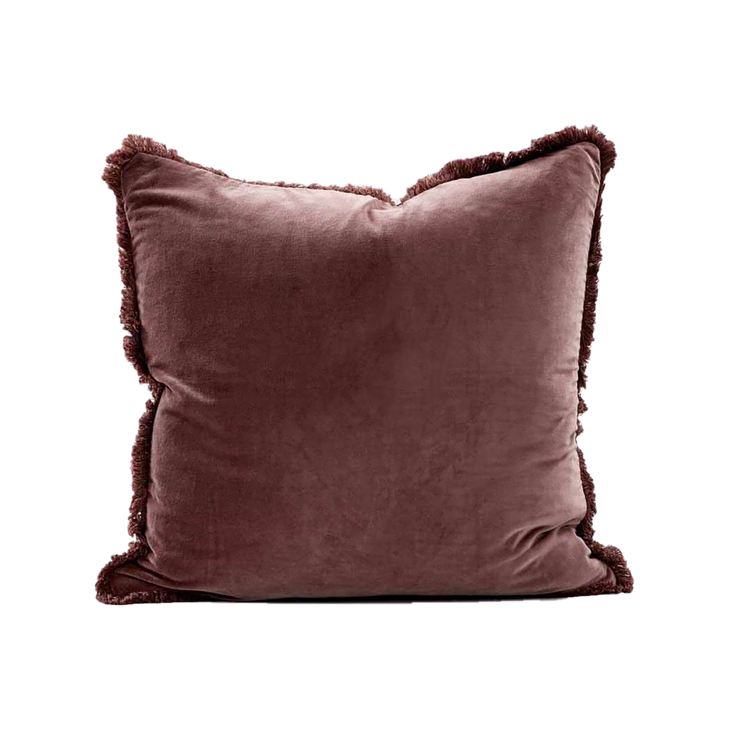 Brown velvet pillow with frayed edges on a white background