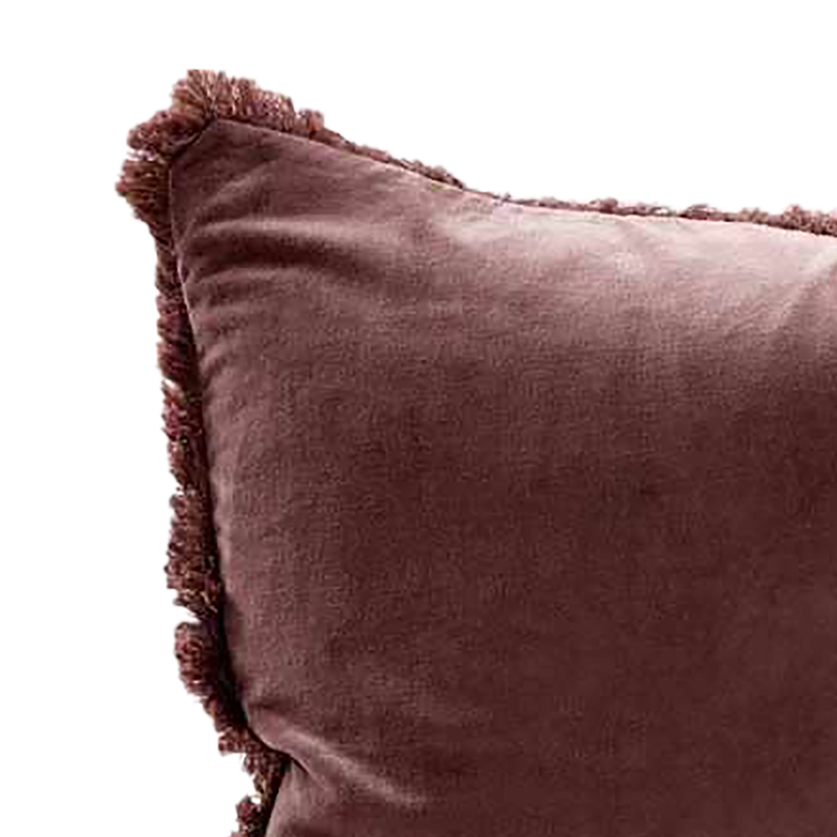 Brown velvet pillow with tassels on a white background