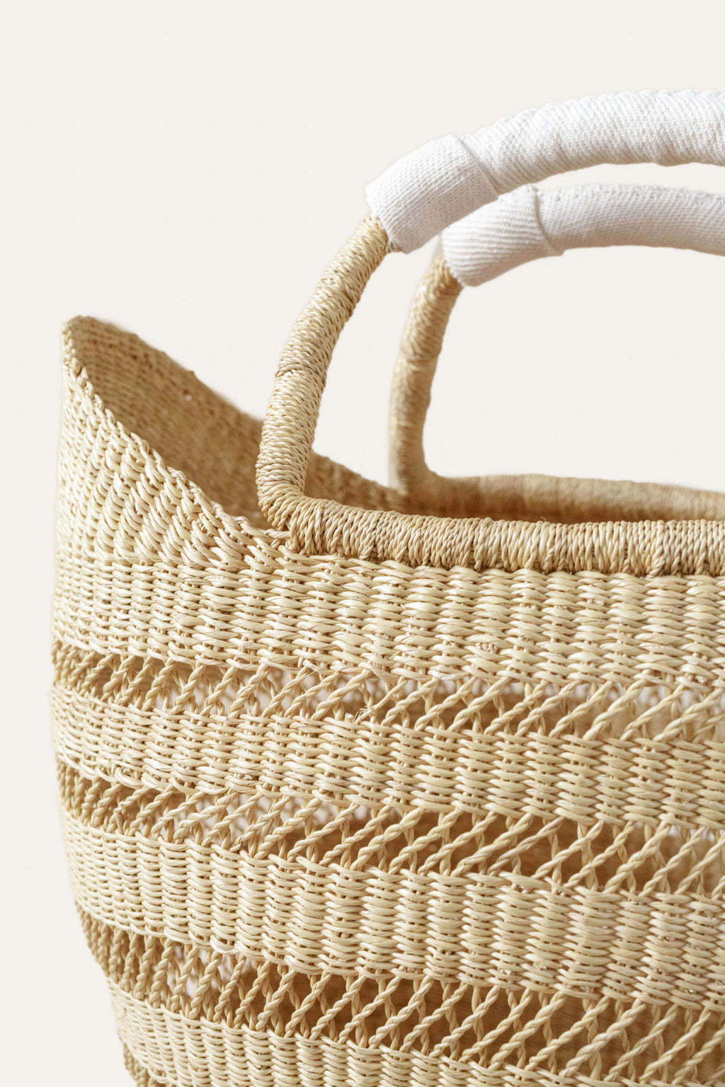 Woven basket with a textured handle on a light background