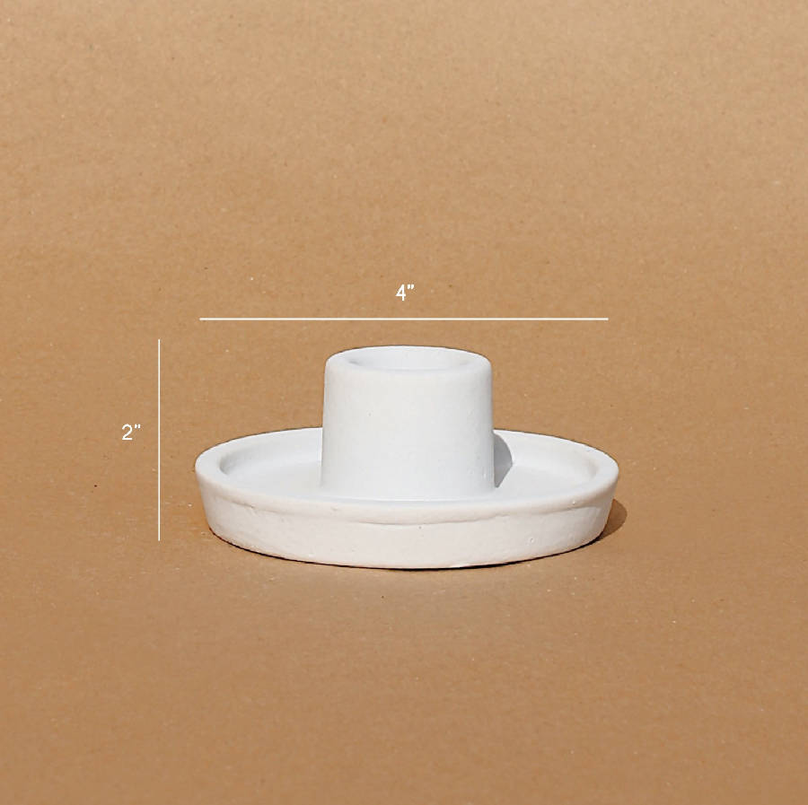 Ceramic candle holder with dimensions on a brown background