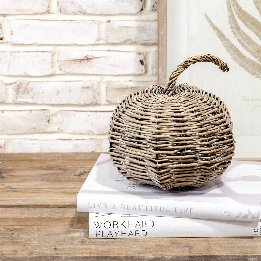 Woven basket on top of books with a brick wall background