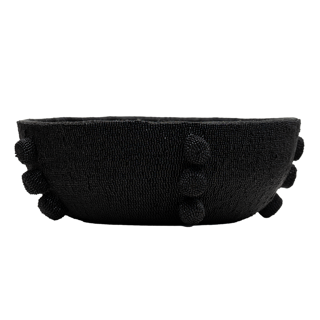 Black headband with pom-pom details on a white background