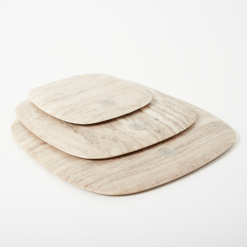 Set of three beige trays on a white background