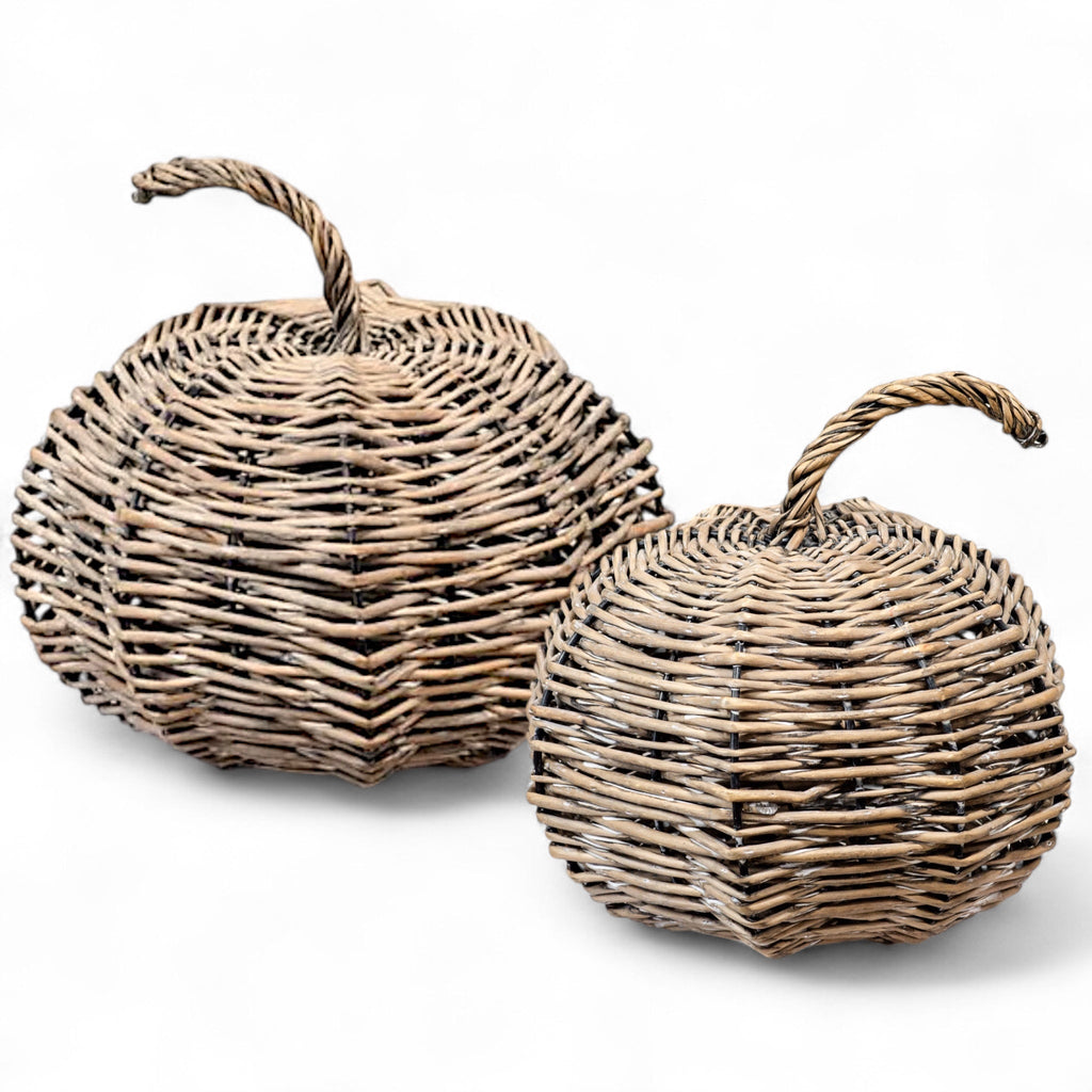 Two woven baskets with handles on a white background