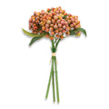 Bouquet of artificial berries with green stems on a white background