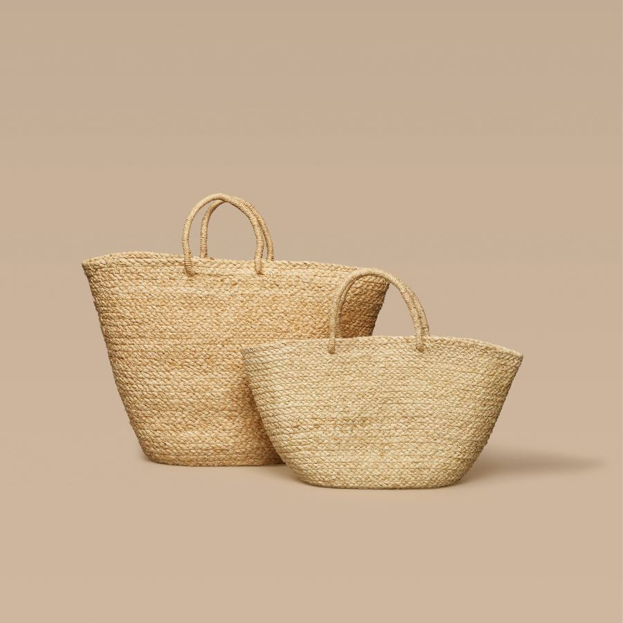Two woven bags on a beige background