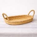 Handwoven natural fiber banana bowl with an organic sculptural shape for kitchen and tabletop styling.