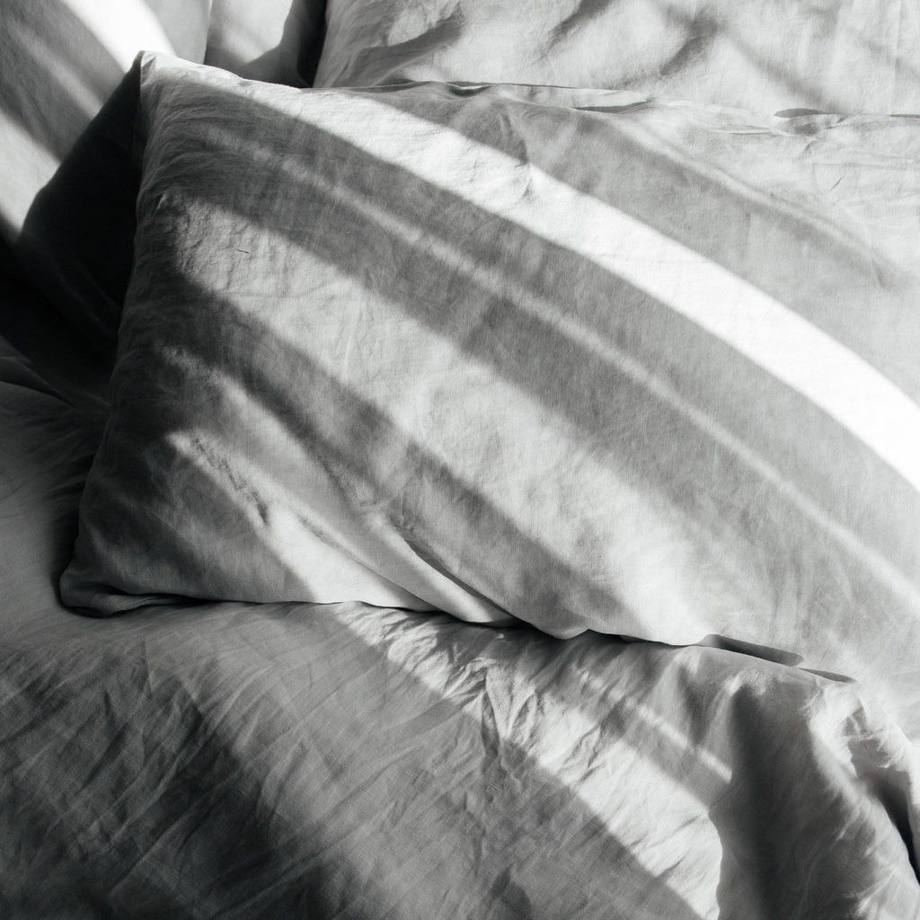 Gray bedding with pillows on a bed