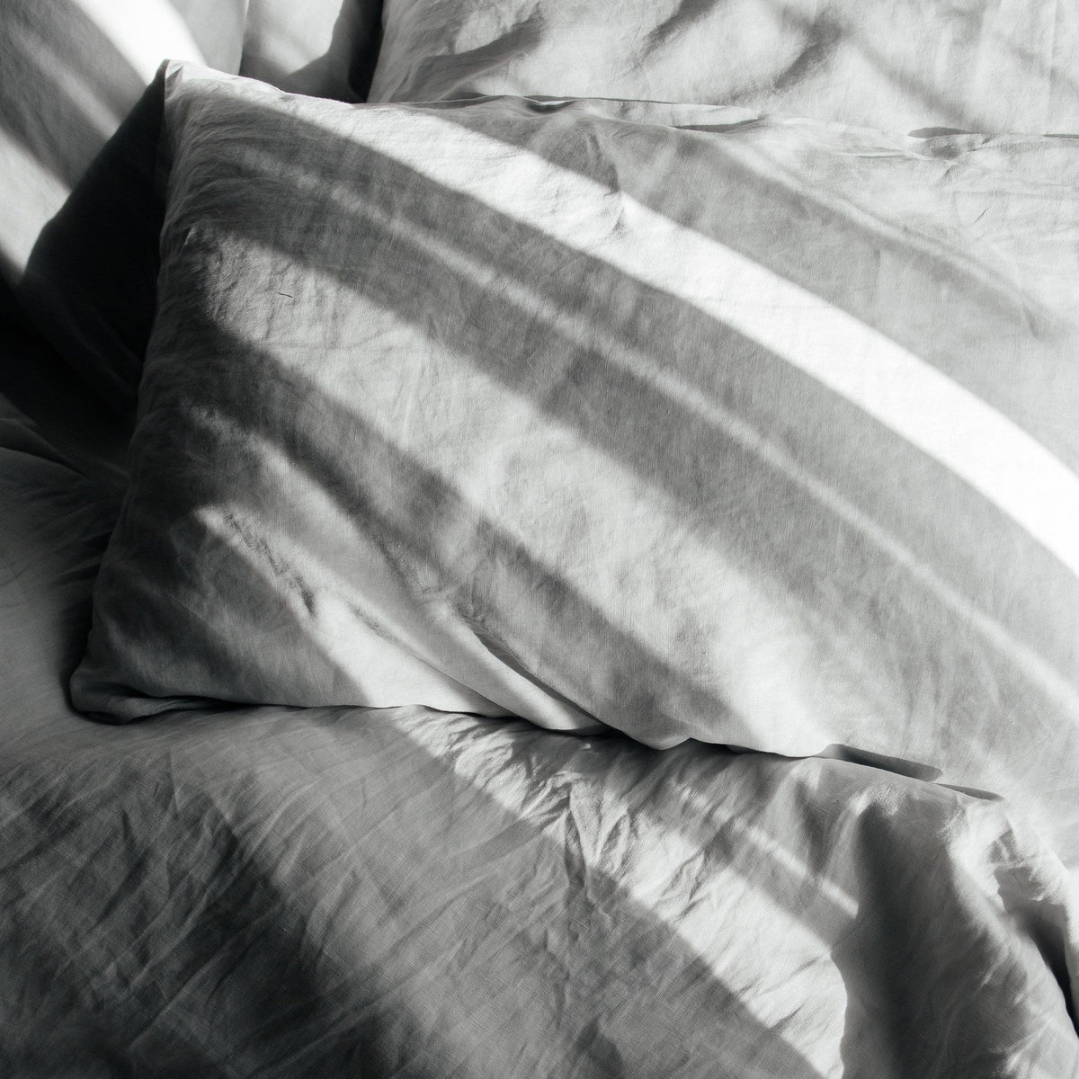 Gray bedding with pillows on a bed