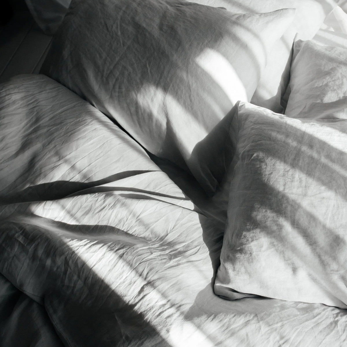Bed with pillows and blankets in soft light