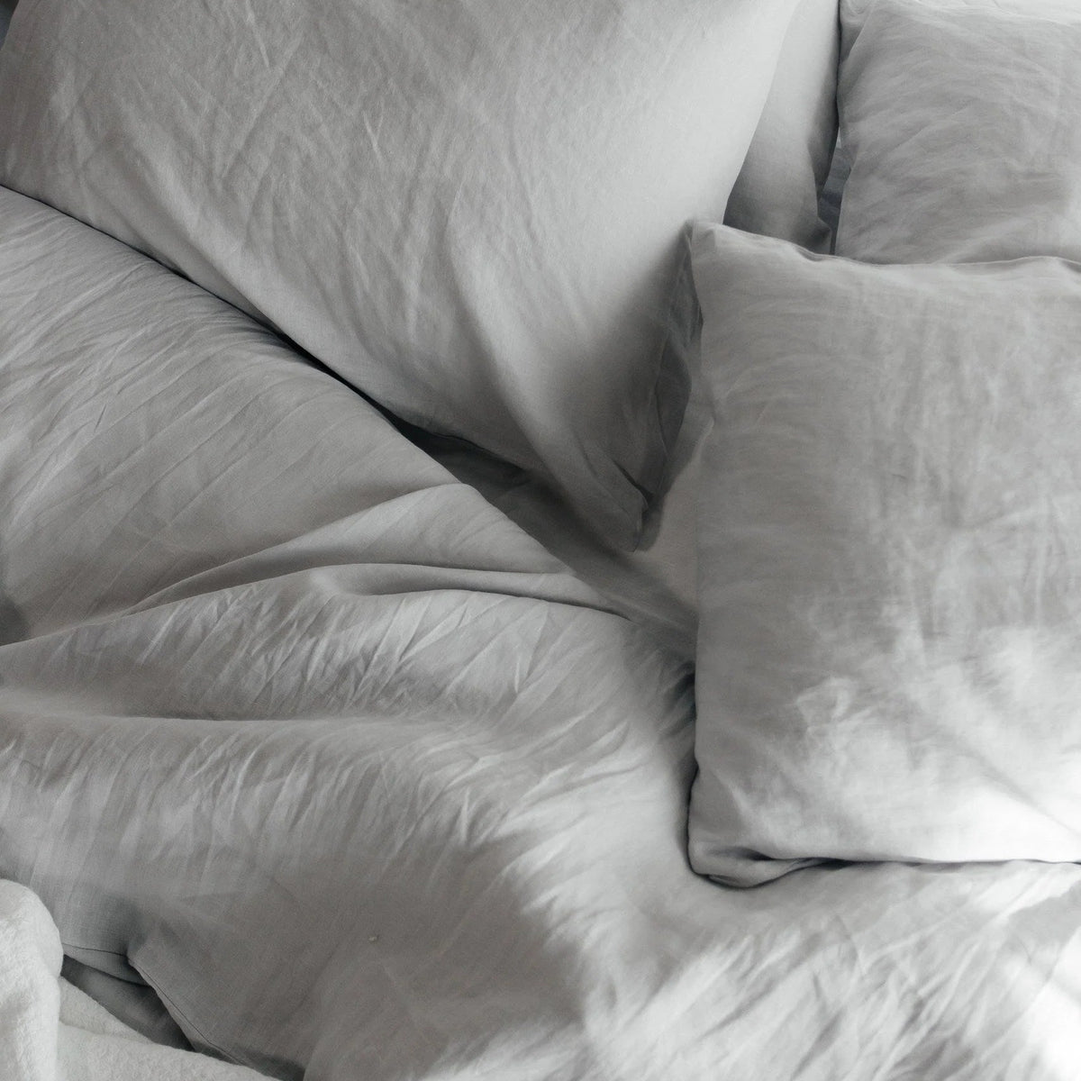 Gray bedding set with pillows on a bed