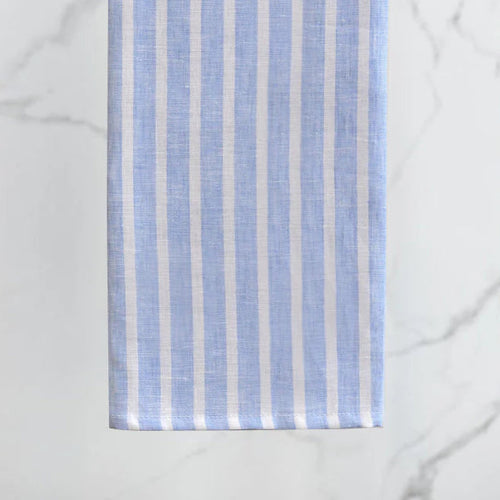 Fabric with blue and white vertical stripes on a light gray background