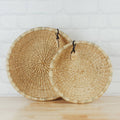 Set of handwoven natural seagrass baskets featuring a shallow bowl design and warm organic texture. Perfect for decorative storage, tabletop styling, kitchen organization, entryway essentials, or creating a relaxed coastal, farmhouse, and European-inspired home aesthetic