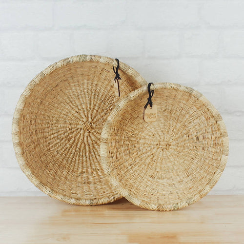 Set of handwoven natural seagrass baskets featuring a shallow bowl design and warm organic texture. Perfect for decorative storage, tabletop styling, kitchen organization, entryway essentials, or creating a relaxed coastal, farmhouse, and European-inspired home aesthetic