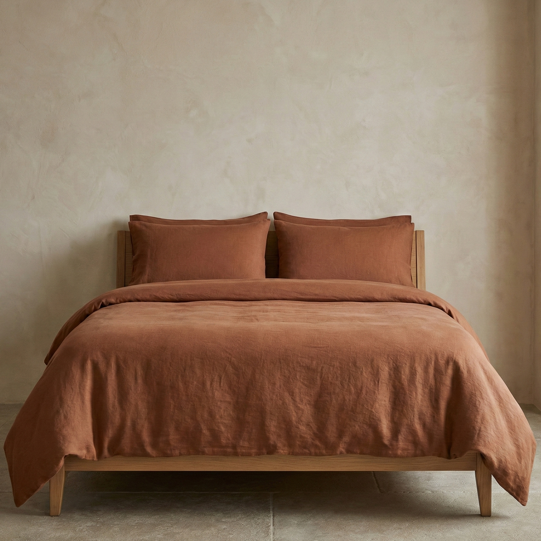 Brown bedding set on a bed against a beige wall