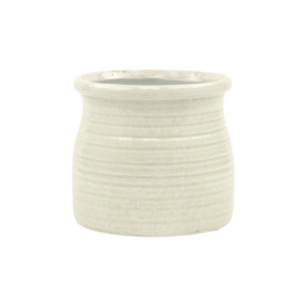 White ceramic planter with textured surface on a white background