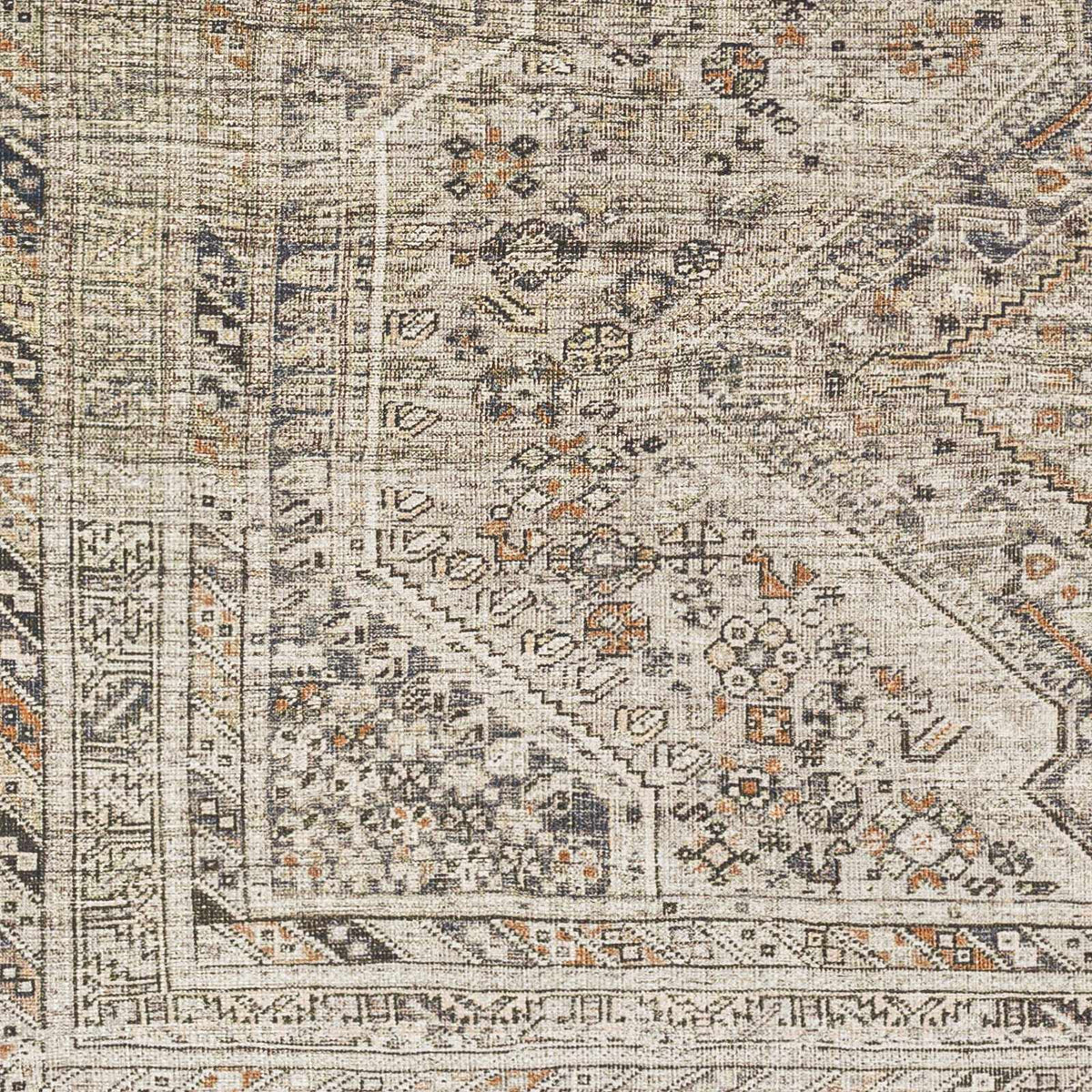 Patterned rug with intricate design in neutral colors