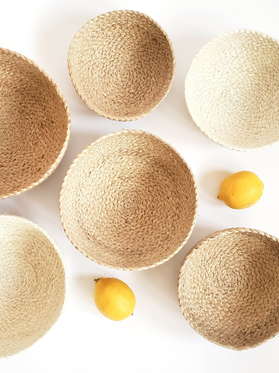 Woven baskets of various sizes on a white background with lemons.
