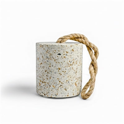 Decorative terrazzo door stop featuring a cylindrical silhouette and natural braided rope handle. Functional home accent with a speckled stone finish, designed to hold doors open while adding timeless style