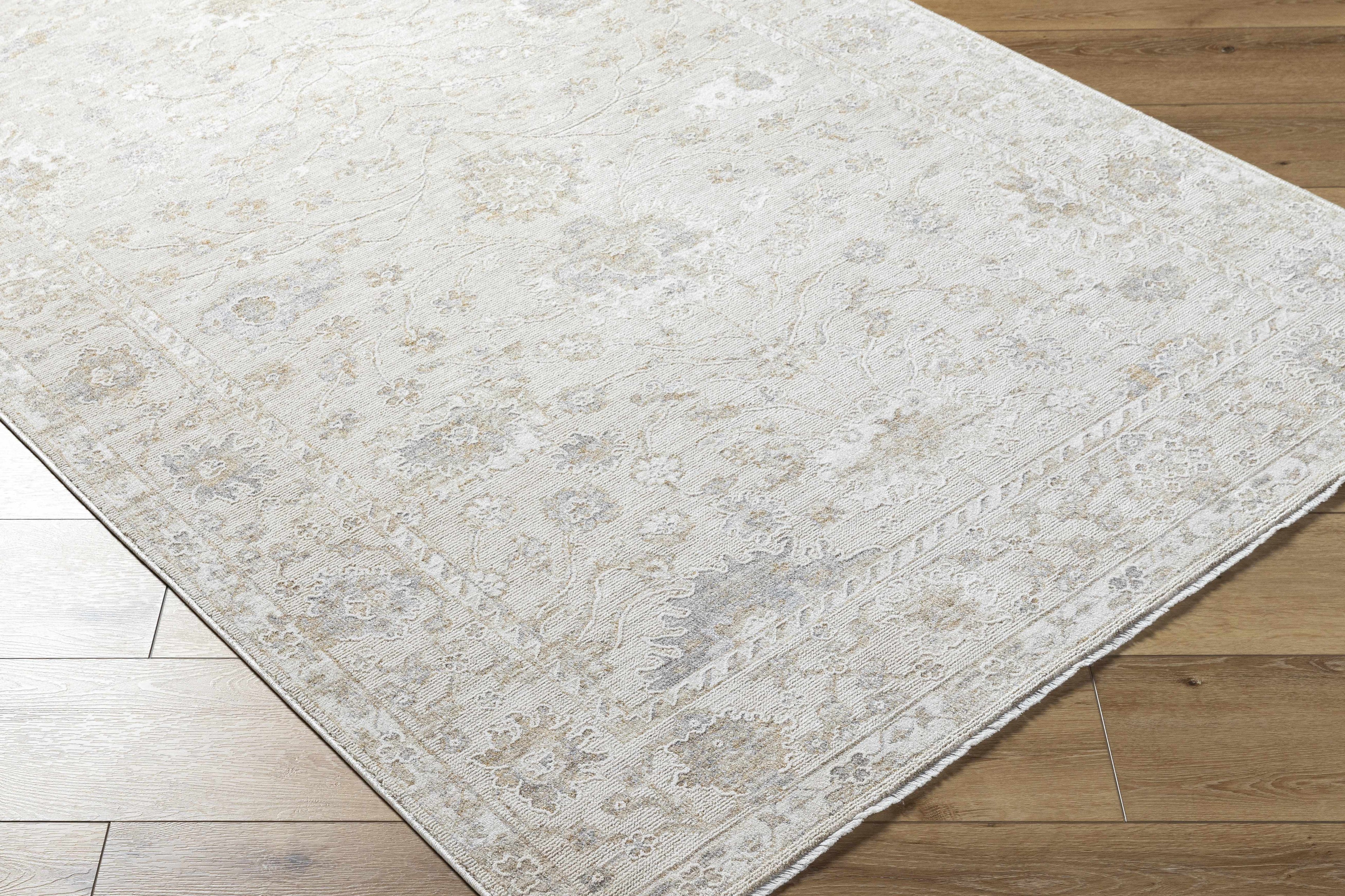 Beige area rug on a wooden floor
