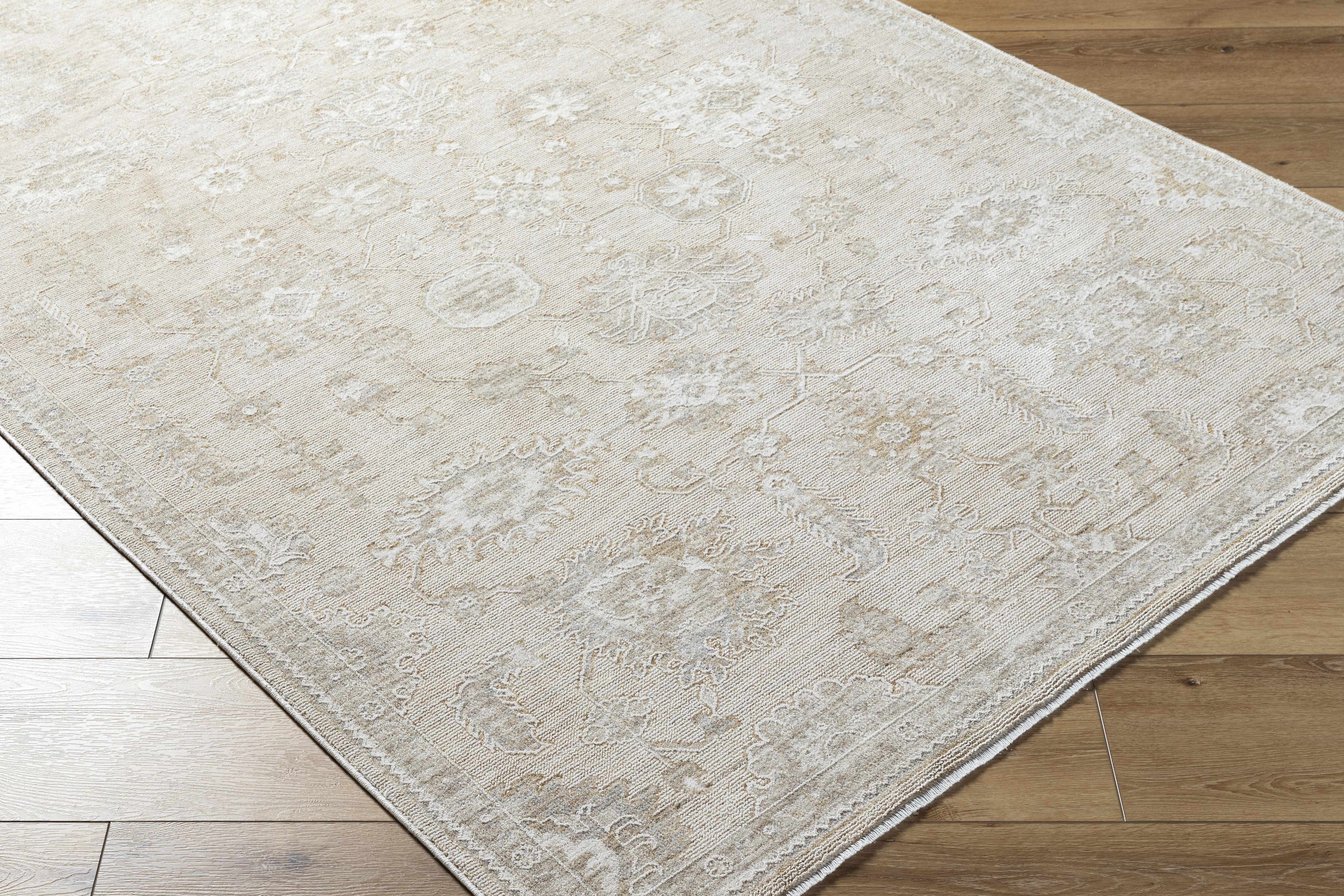 Beige patterned rug on a wooden floor