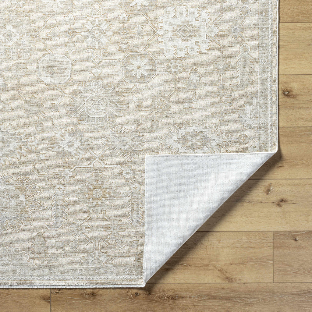 Beige patterned rug on a wooden floor
