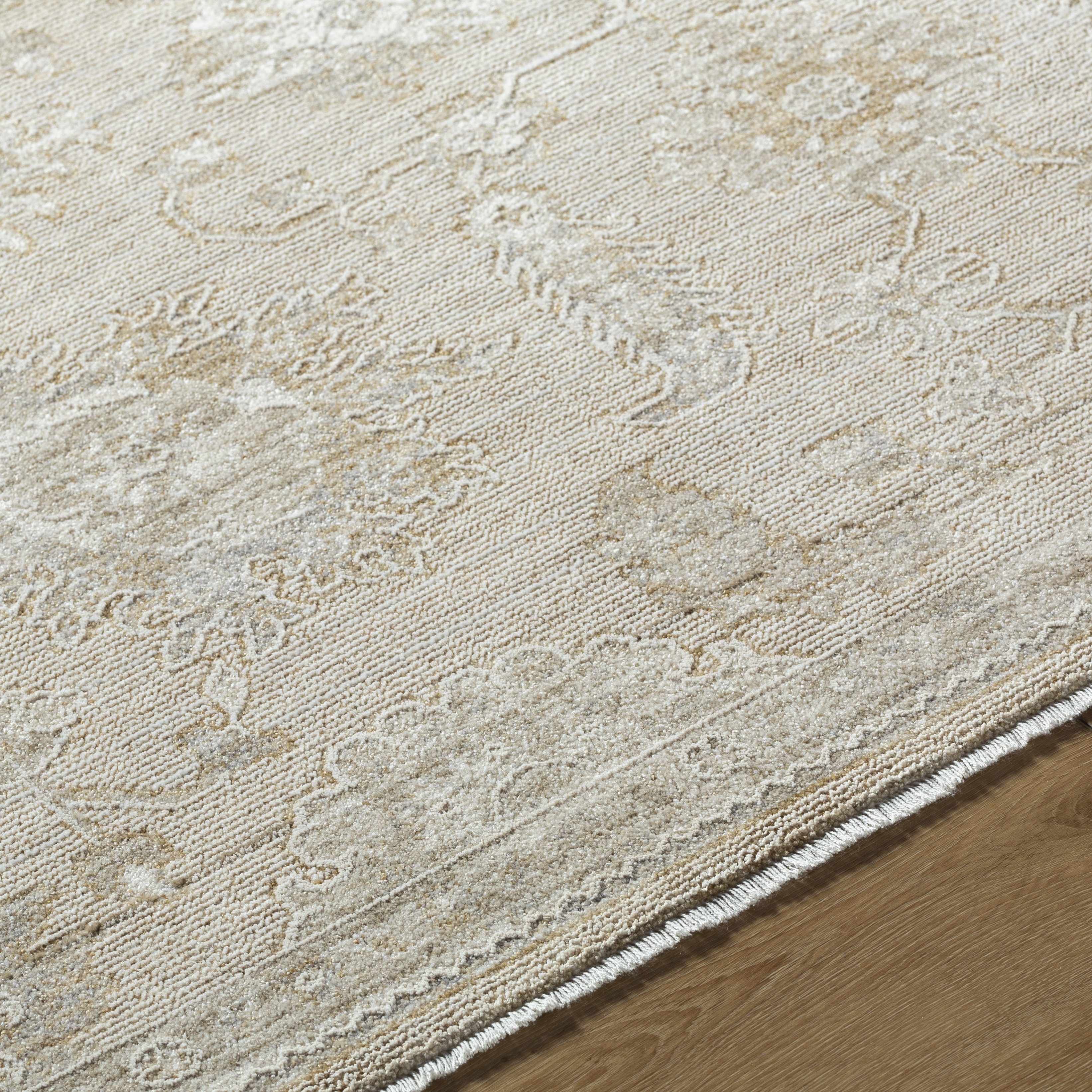 Close-up of a textured beige rug on a wooden floor